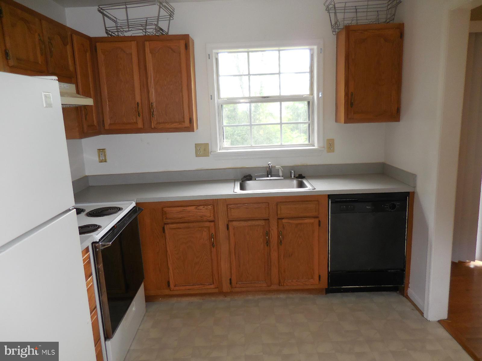 6322 Springbrook Lane Clinton, MD 20735 - Photo 6 of 9 a kitchen with a sink a stove and a refrigerator