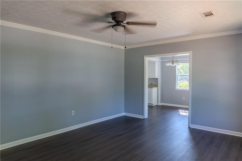 53 Washington Drive Forsyth, GA 31029 - Photo 2 of 19 a view of an empty room with window and wooden floor