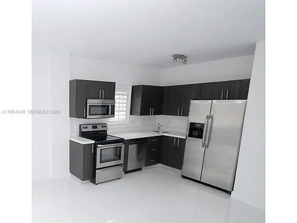 a kitchen with stainless steel appliances a refrigerator and a stove