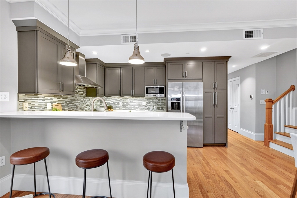 13 Howell Street, Unit 3 Boston, MA 02125 - Photo 11 of 31 a kitchen with stainless steel appliances granite countertop a sink and a refrigerator