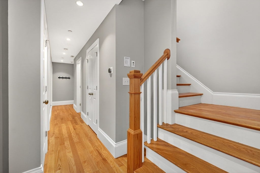 13 Howell Street, Unit 3 Boston, MA 02125 - Photo 12 of 31 a view of a hallway with wooden floor and staircase