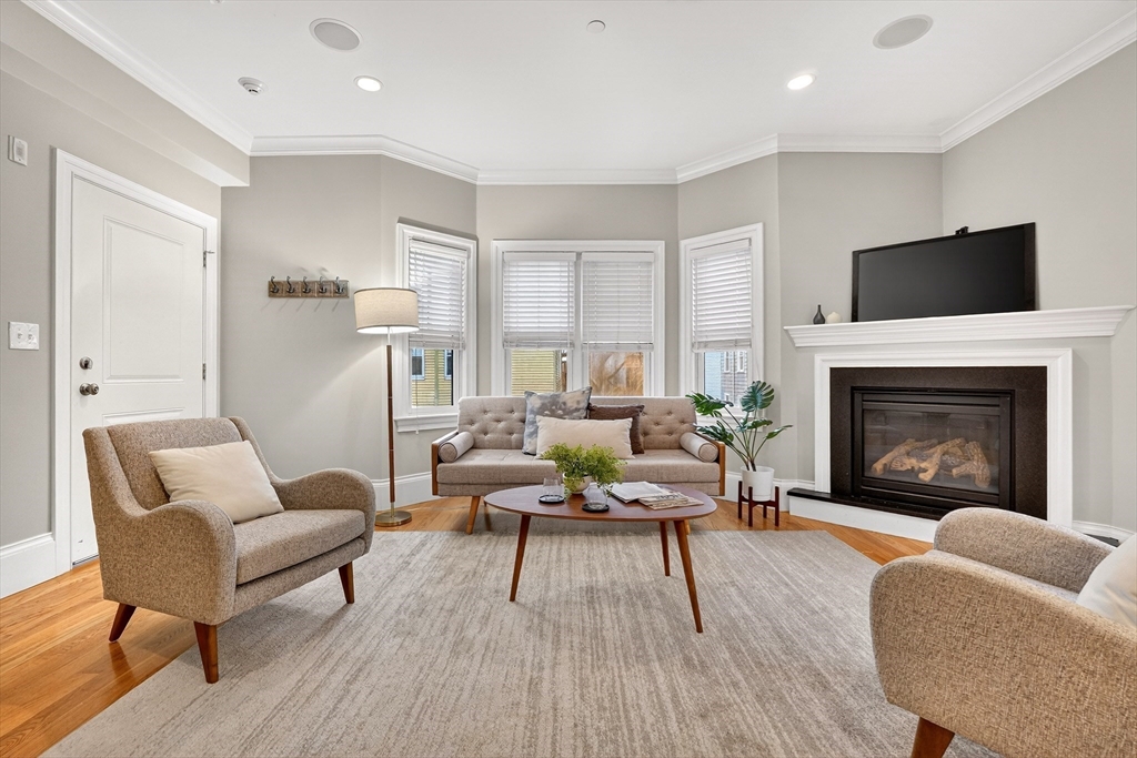 13 Howell Street, Unit 3 Boston, MA 02125 - Photo 2 of 31 a living room with furniture and a fireplace