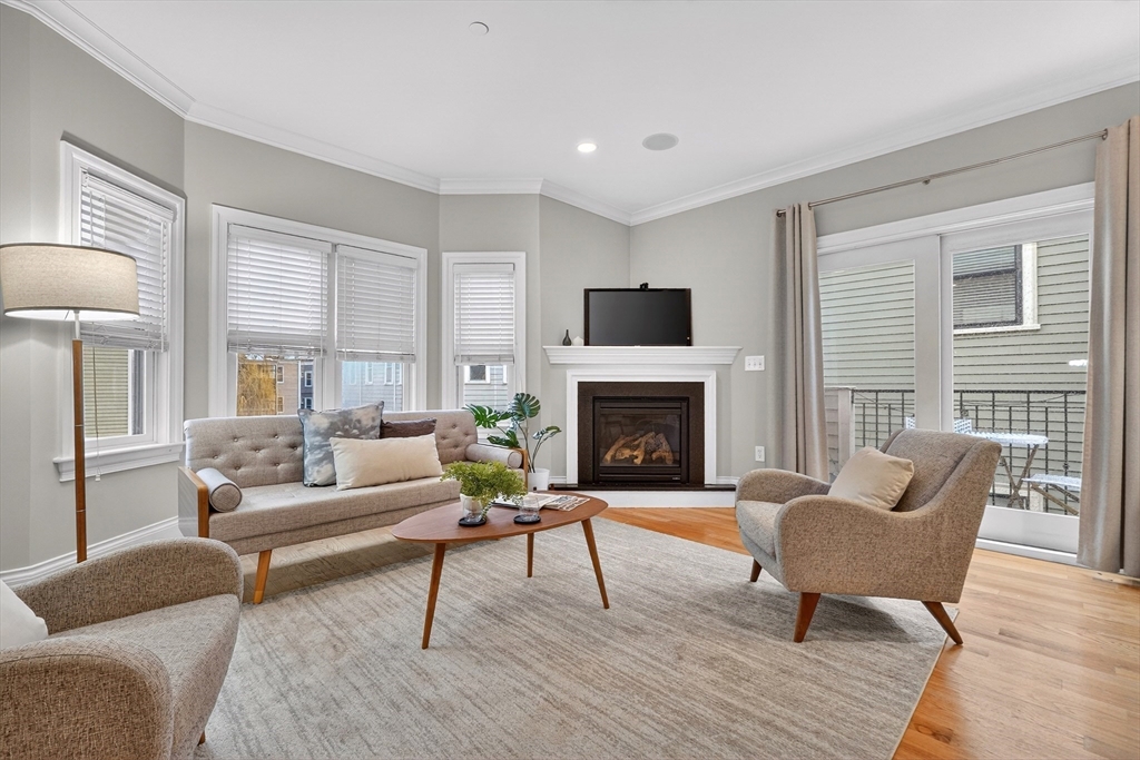 13 Howell Street, Unit 3 Boston, MA 02125 - Photo 4 of 31 a living room with furniture and a fireplace
