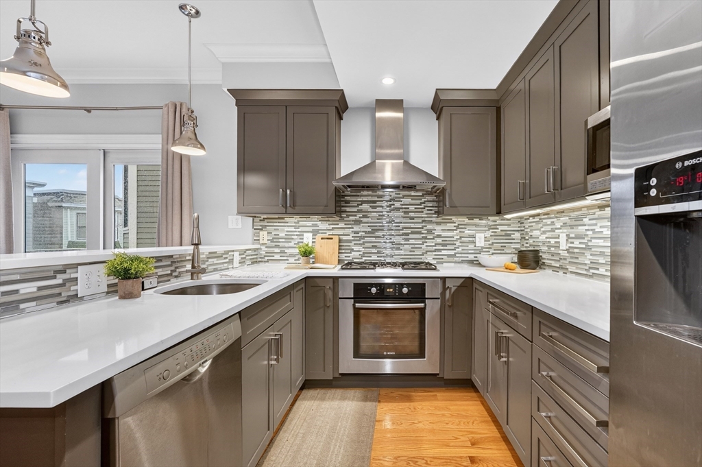 13 Howell Street, Unit 3 Boston, MA 02125 - Photo 8 of 31 a kitchen with a sink stove and cabinets