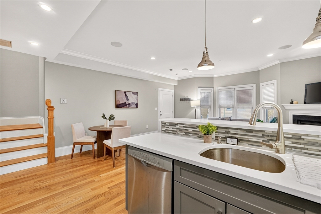 13 Howell Street, Unit 3 Boston, MA 02125 - Photo 9 of 31 a kitchen with a sink cabinets and wooden floor