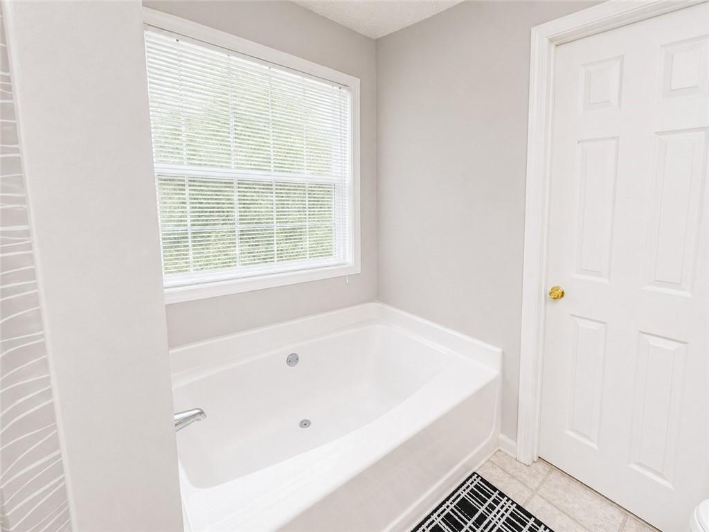 6936 Red Bone Way Stonecrest, GA 30038 - Photo 14 of 17 a white bath tub sitting next to a window