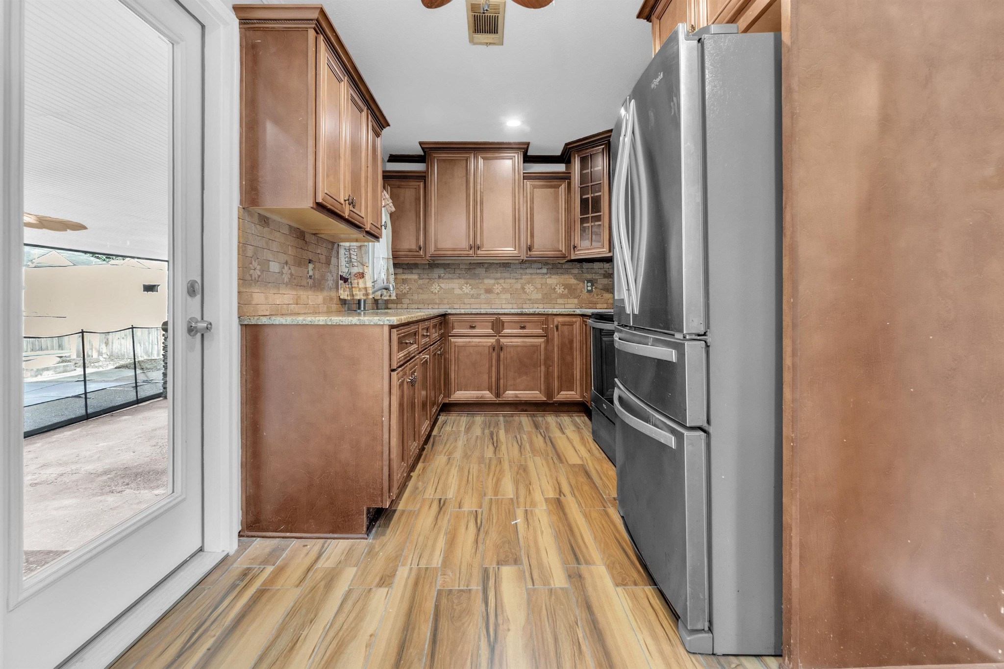 1903 Capri Road Memphis, TN 38117 - Photo 7 of 20 a kitchen with kitchen island wooden floor center island and stainless steel appliances