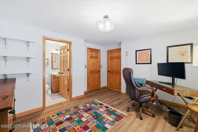 a living room with furniture a fireplace and a floor to ceiling window