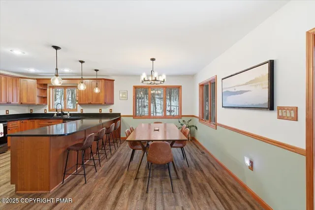 a kitchen with stainless steel appliances granite countertop a refrigerator a sink a stove with wooden cabinets