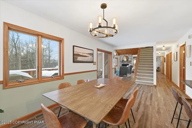 a kitchen with stainless steel appliances granite countertop a stove a sink and a wooden floors