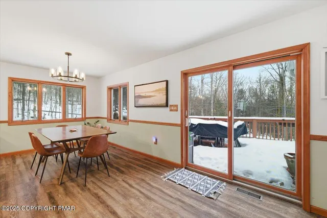 a spacious bedroom with a bed and wooden floor