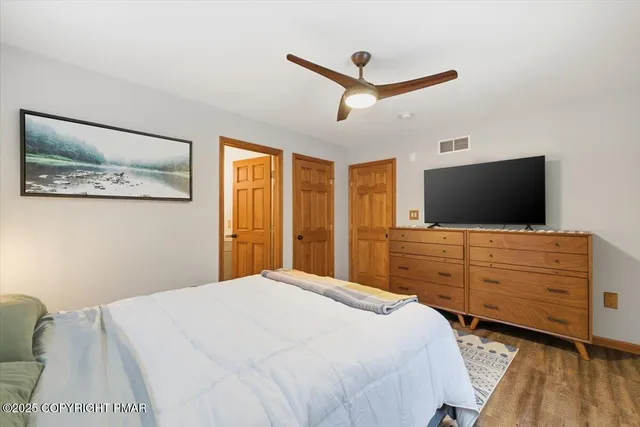 a front view of a house with a yard covered in snow