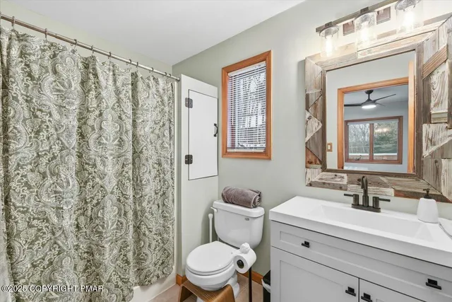 a view of a house with a yard covered in snow
