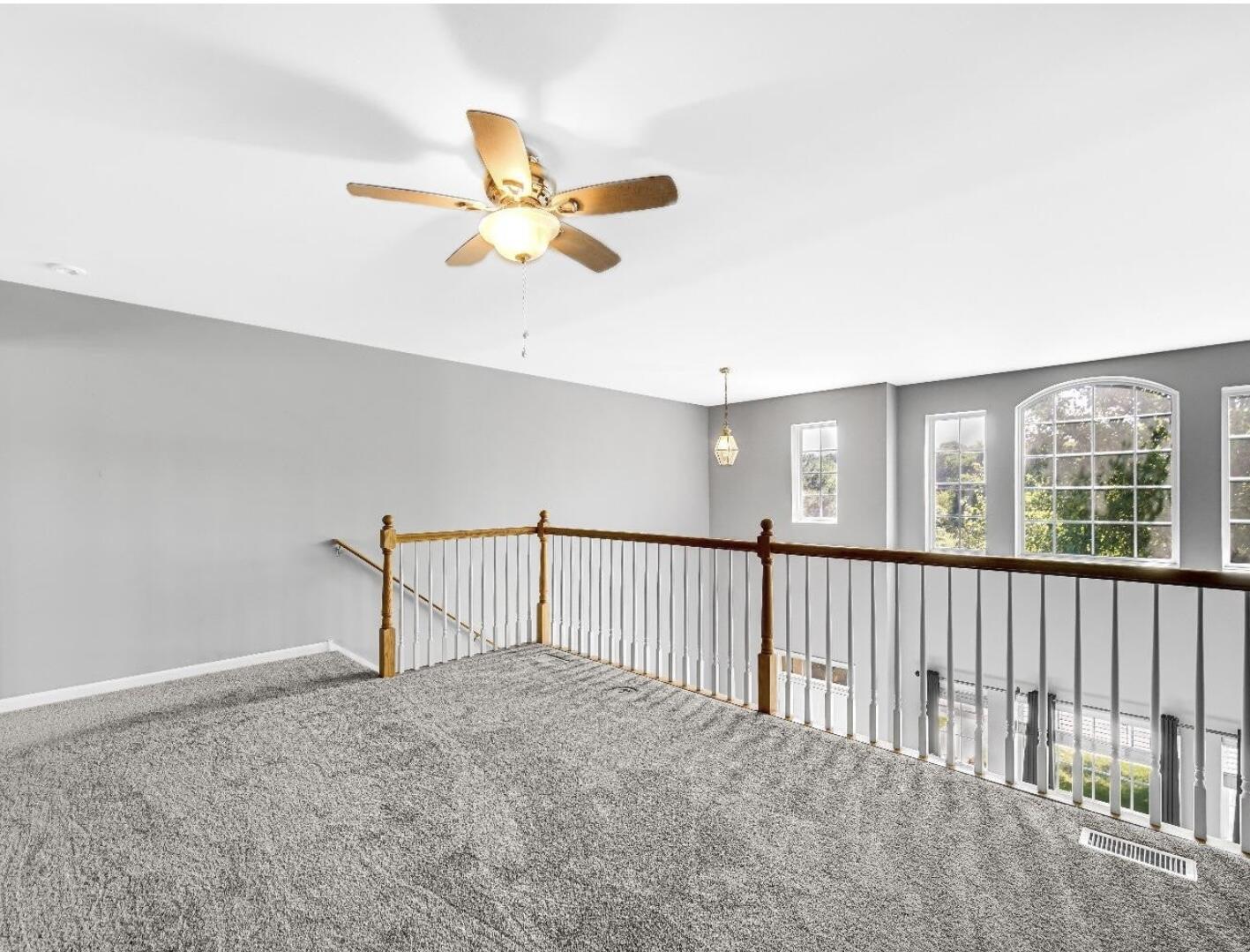 11664 Broadway Crown Point, IN 46307 - Photo 13 of 19 a view of a livingroom with a ceiling fan and window