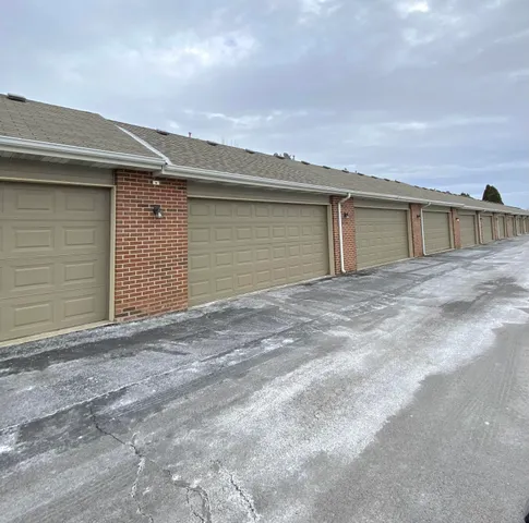 front view of a brick house with a yard