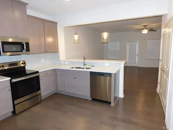 a kitchen with a sink stove and microwave