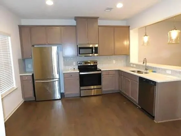 a kitchen with a sink appliances and cabinets