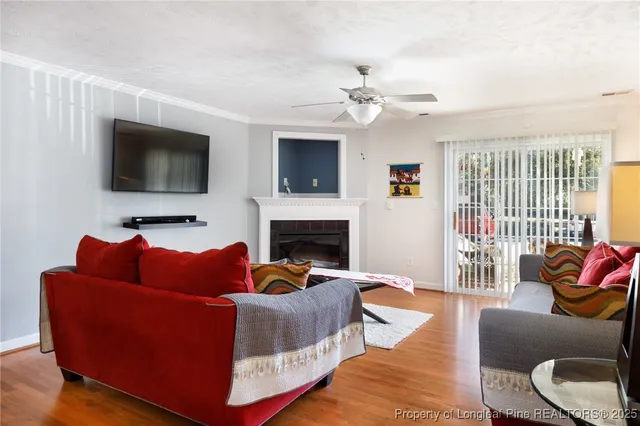 a living room with furniture fireplace and flat screen tv