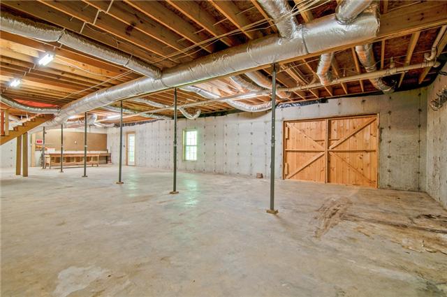 2446 Tower Road Nunnelly, TN 37137 - Photo 13 of 20 This basement is impressive. Poured wall foundation with door leading to the back for easy access to store lawn/garden equipment. Opening is large enough to park a car.