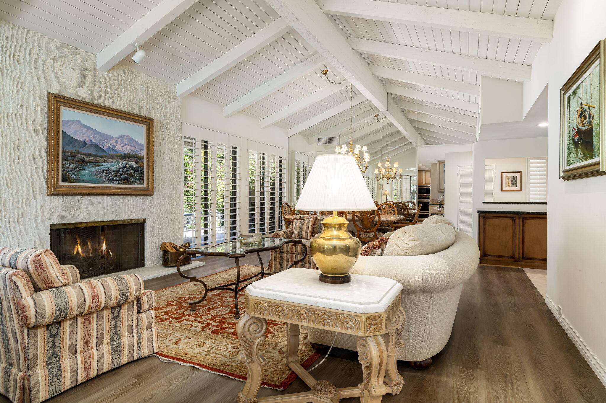 5 Stanford Drive Rancho Mirage, CA 92270 - Photo 17 of 53 a living room with furniture a fireplace and a table