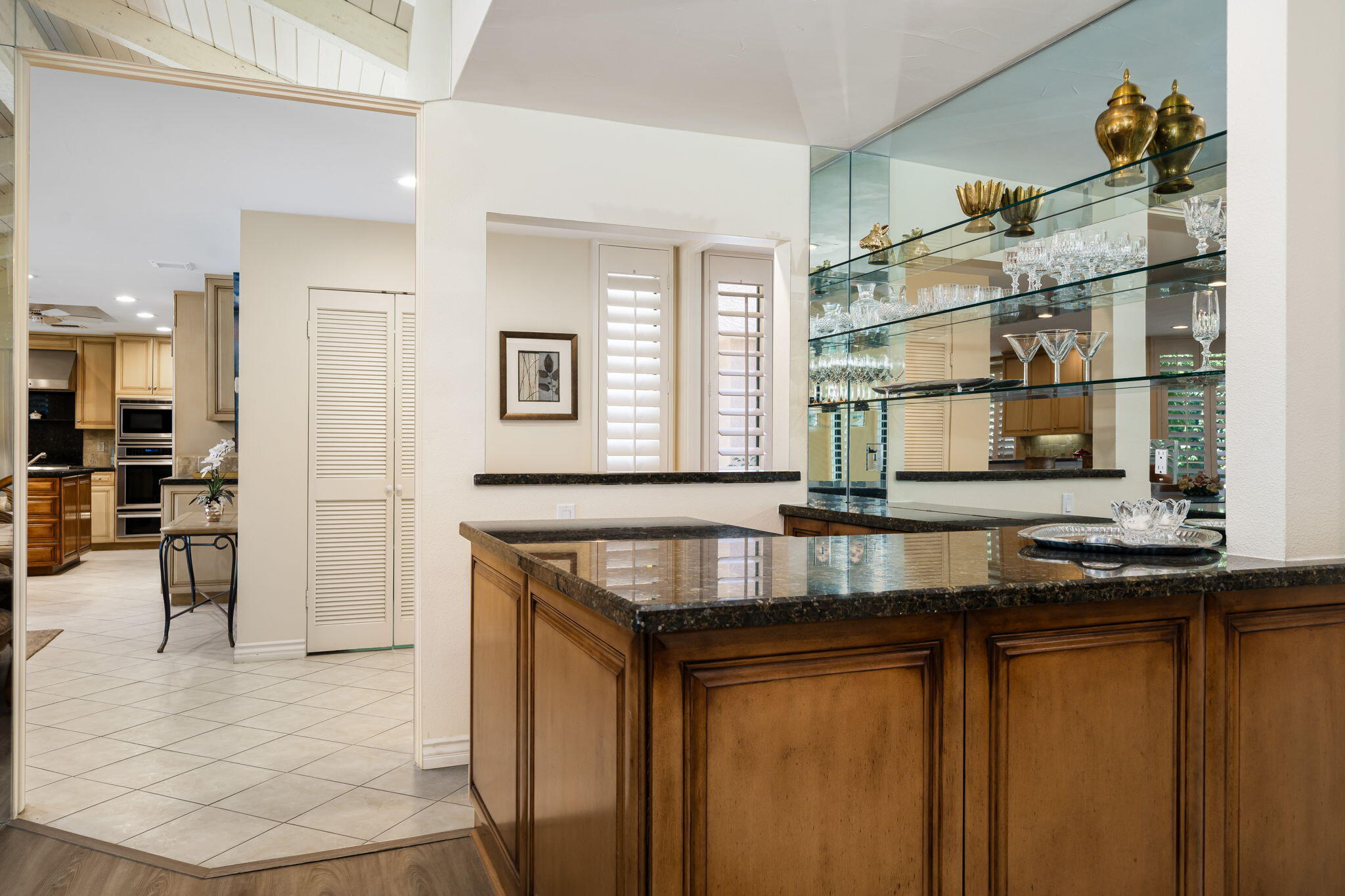 5 Stanford Drive Rancho Mirage, CA 92270 - Photo 21 of 53 a kitchen with stainless steel appliances granite countertop a sink and a refrigerator