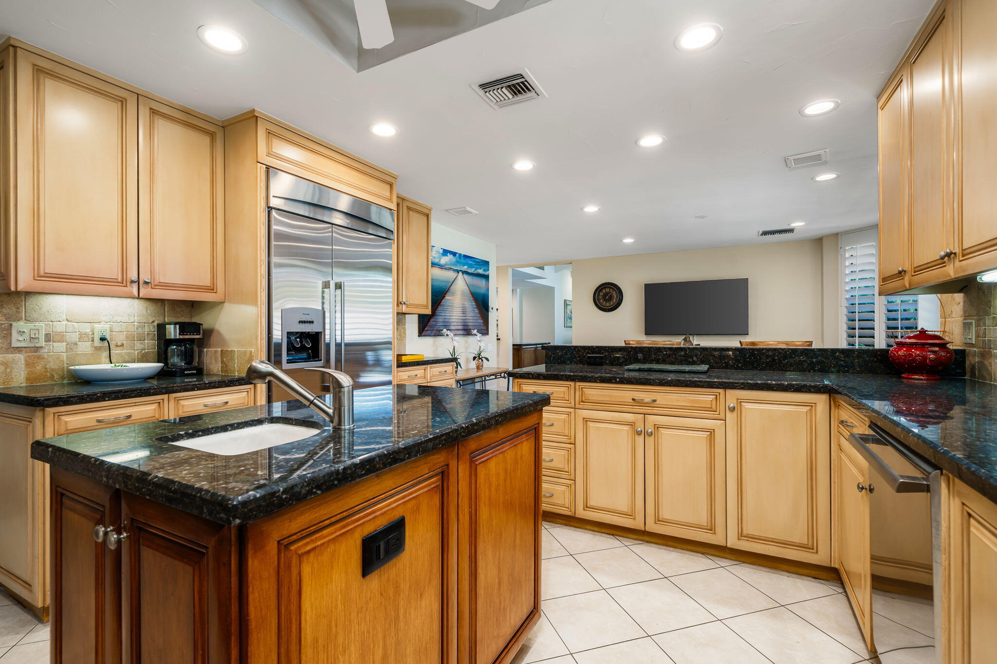 5 Stanford Drive Rancho Mirage, CA 92270 - Photo 27 of 53 a kitchen with granite countertop kitchen island sink stove and cabinets