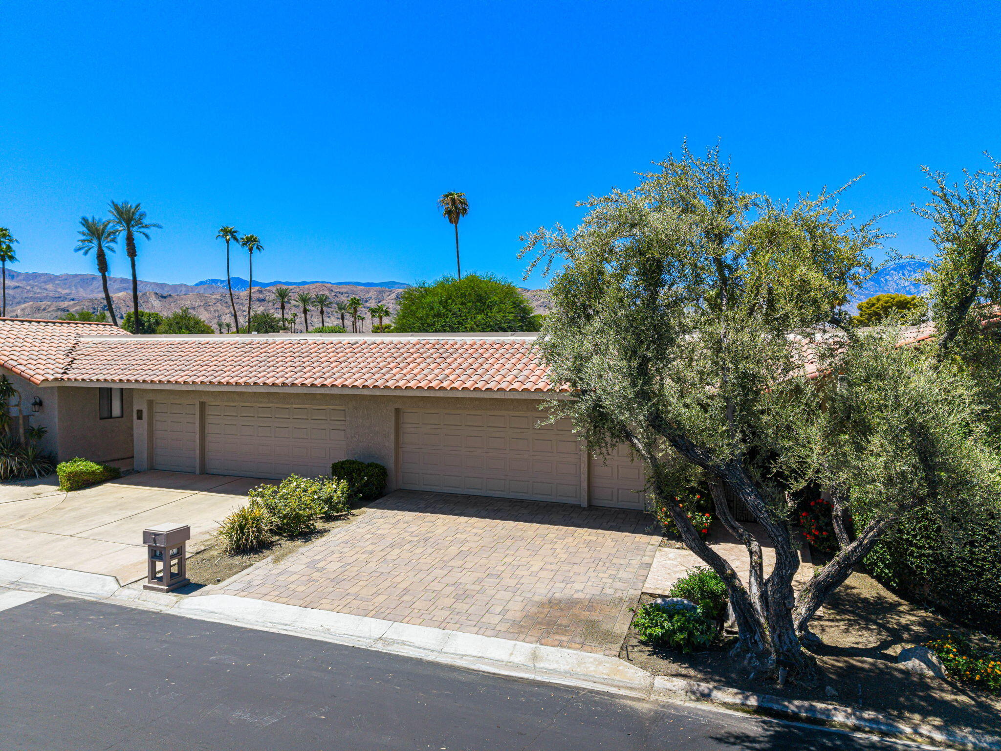 5 Stanford Drive Rancho Mirage, CA 92270 - Photo 3 of 53 a front view of a house with a garage