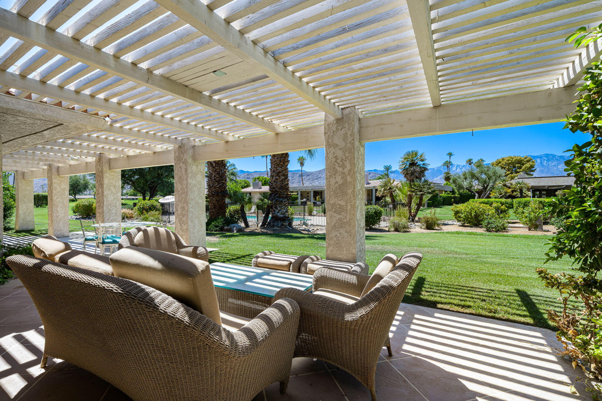 5 Stanford Drive Rancho Mirage, CA 92270 - Photo 34 of 53 a view of a patio with couches table and chairs and potted plants