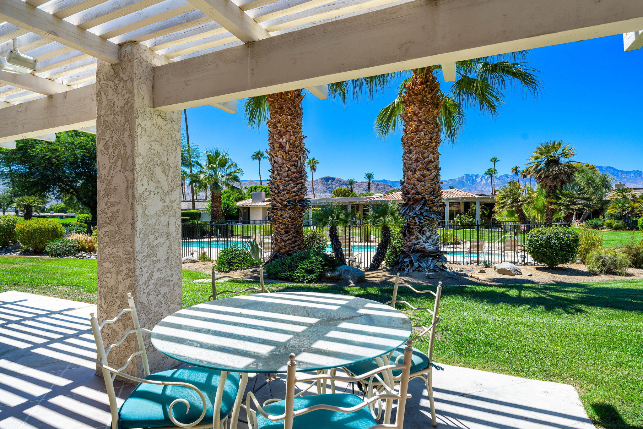 5 Stanford Drive Rancho Mirage, CA 92270 - Photo 36 of 53 a view of a chairs and table in patio with a yard