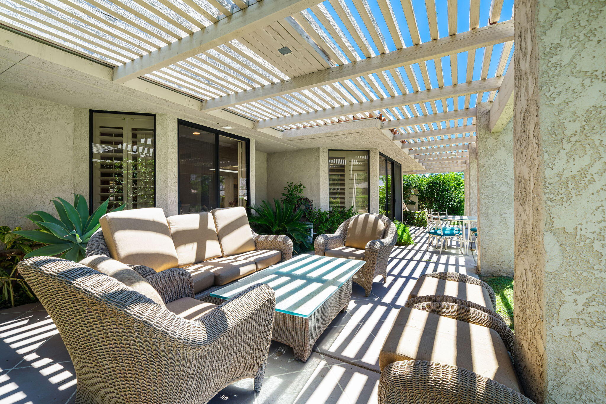 5 Stanford Drive Rancho Mirage, CA 92270 - Photo 39 of 53 a view of a patio with couches table and chairs and potted plants