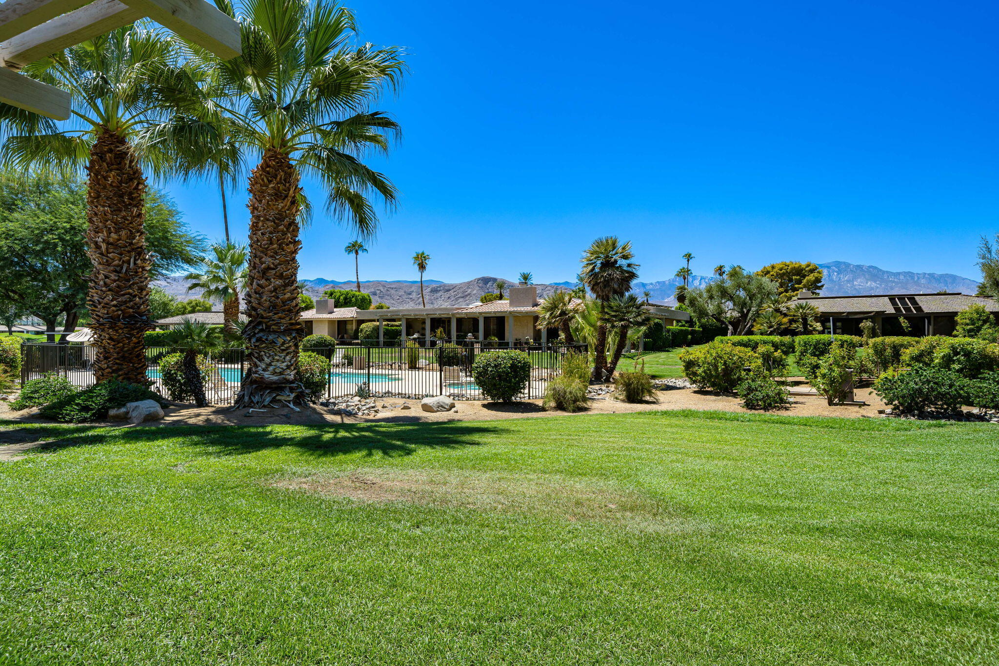 5 Stanford Drive Rancho Mirage, CA 92270 - Photo 40 of 53 a view of a house with a big yard and potted plants and large trees