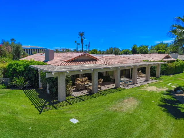 a view of a house with backyard porch and sitting area