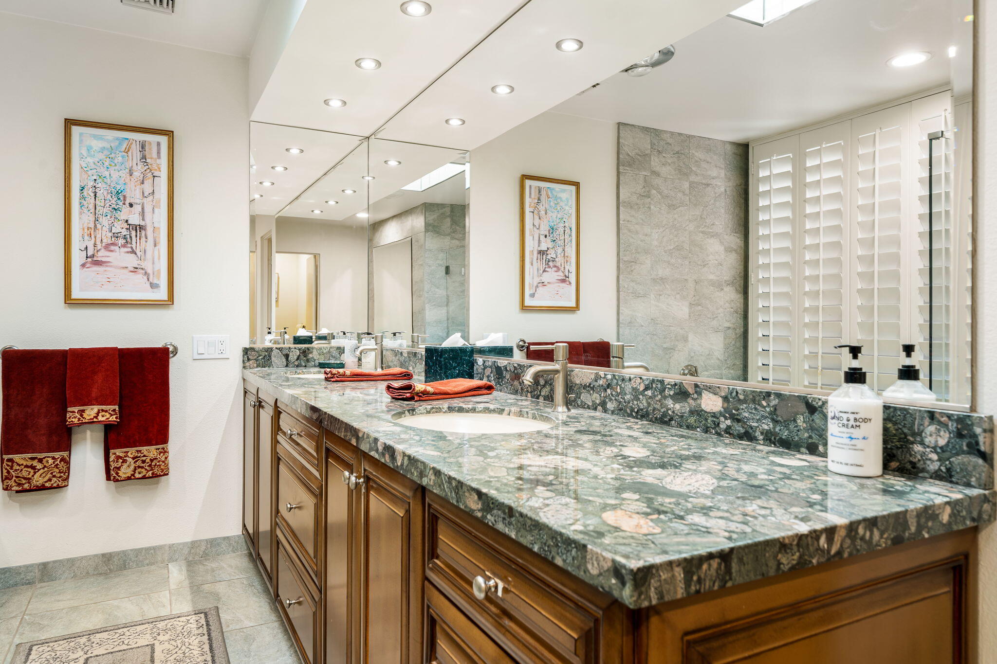 5 Stanford Drive Rancho Mirage, CA 92270 - Photo 46 of 53 a bathroom with a granite countertop sink and a mirror