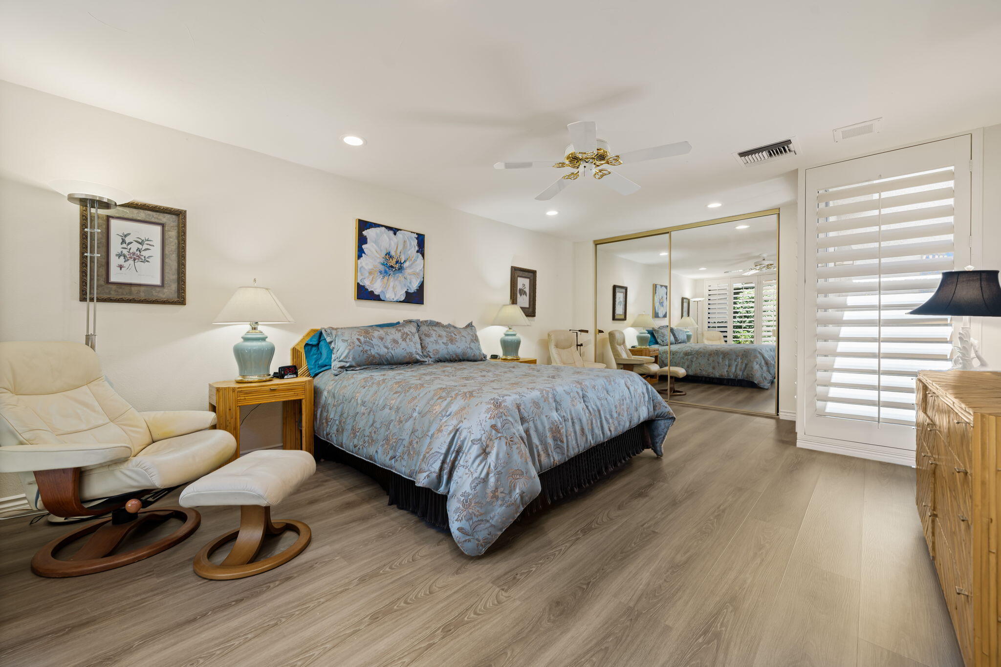 5 Stanford Drive Rancho Mirage, CA 92270 - Photo 48 of 53 a spacious bedroom with a bed a couch and dresser