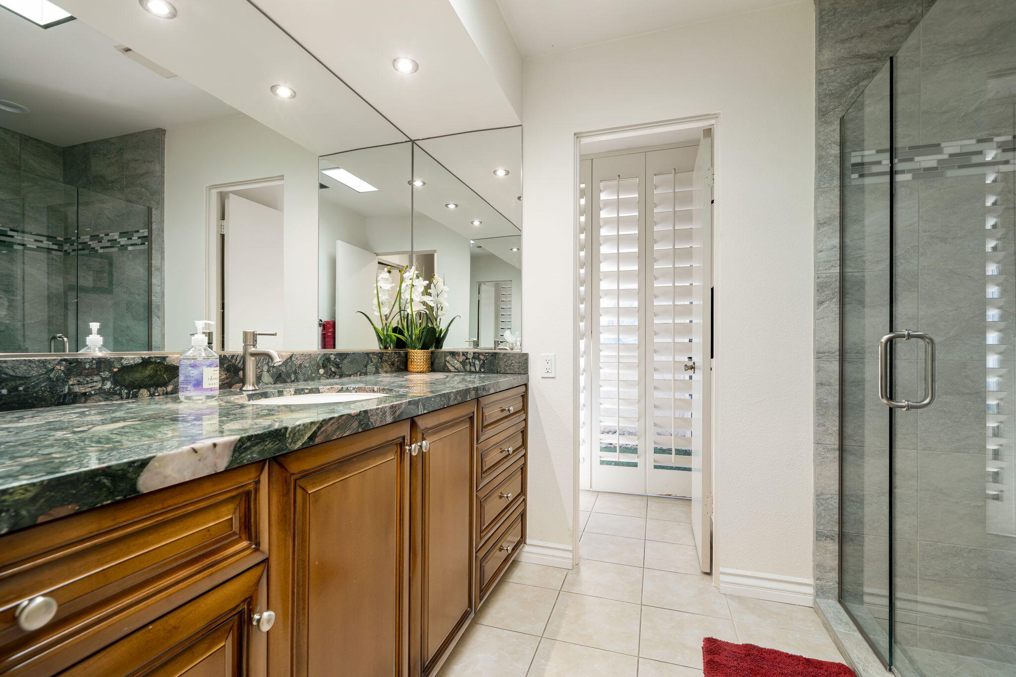 5 Stanford Drive Rancho Mirage, CA 92270 - Photo 49 of 53 a bathroom with a granite countertop sink and a mirror