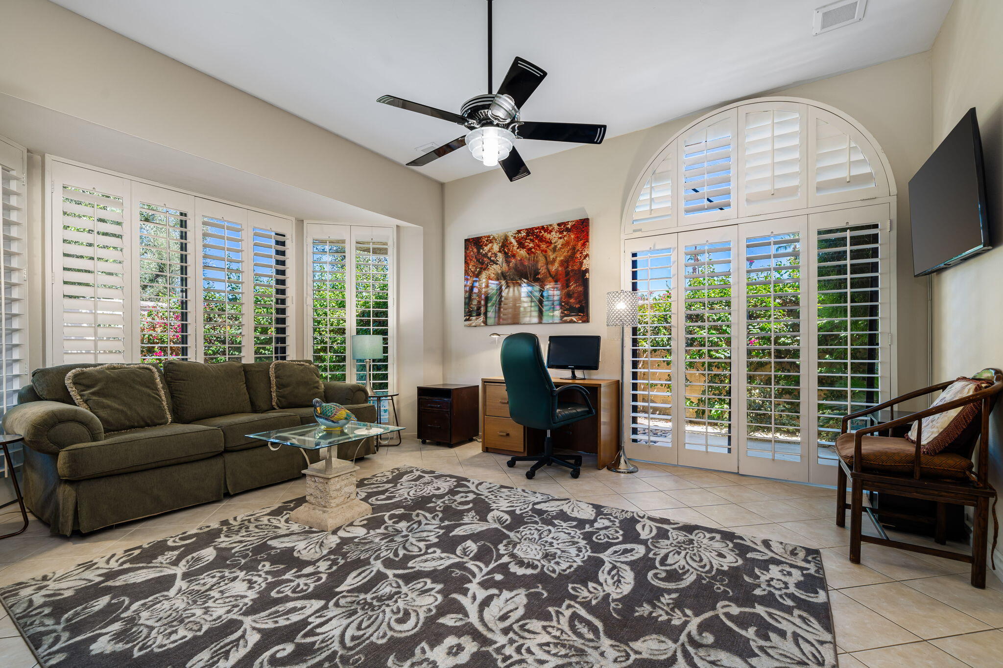 5 Stanford Drive Rancho Mirage, CA 92270 - Photo 50 of 53 a living room with furniture a large window and a flat screen tv