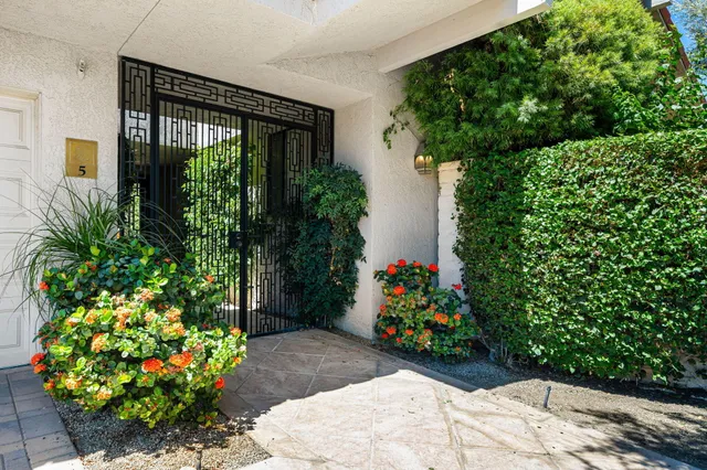 a view of a house with potted plants