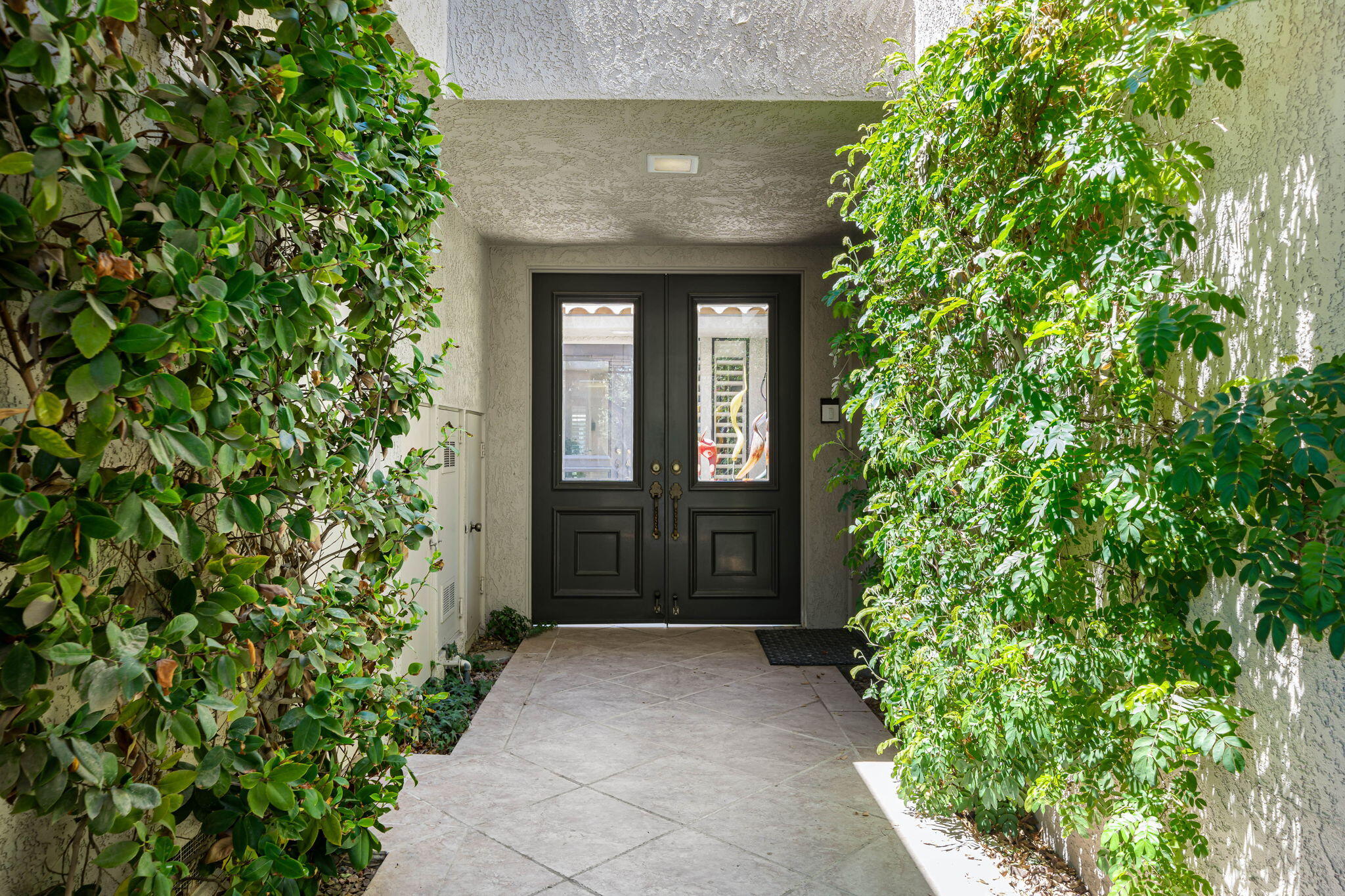 5 Stanford Drive Rancho Mirage, CA 92270 - Photo 8 of 53 an entrance to house with yard and green space