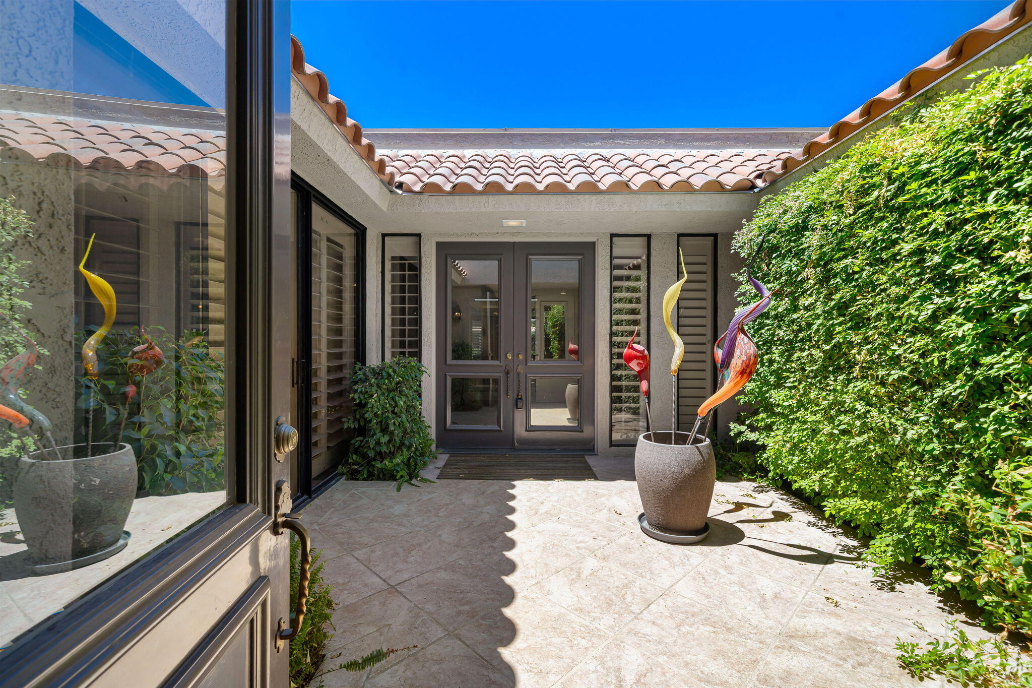 5 Stanford Drive Rancho Mirage, CA 92270 - Photo 9 of 53 a view of a house with potted plants