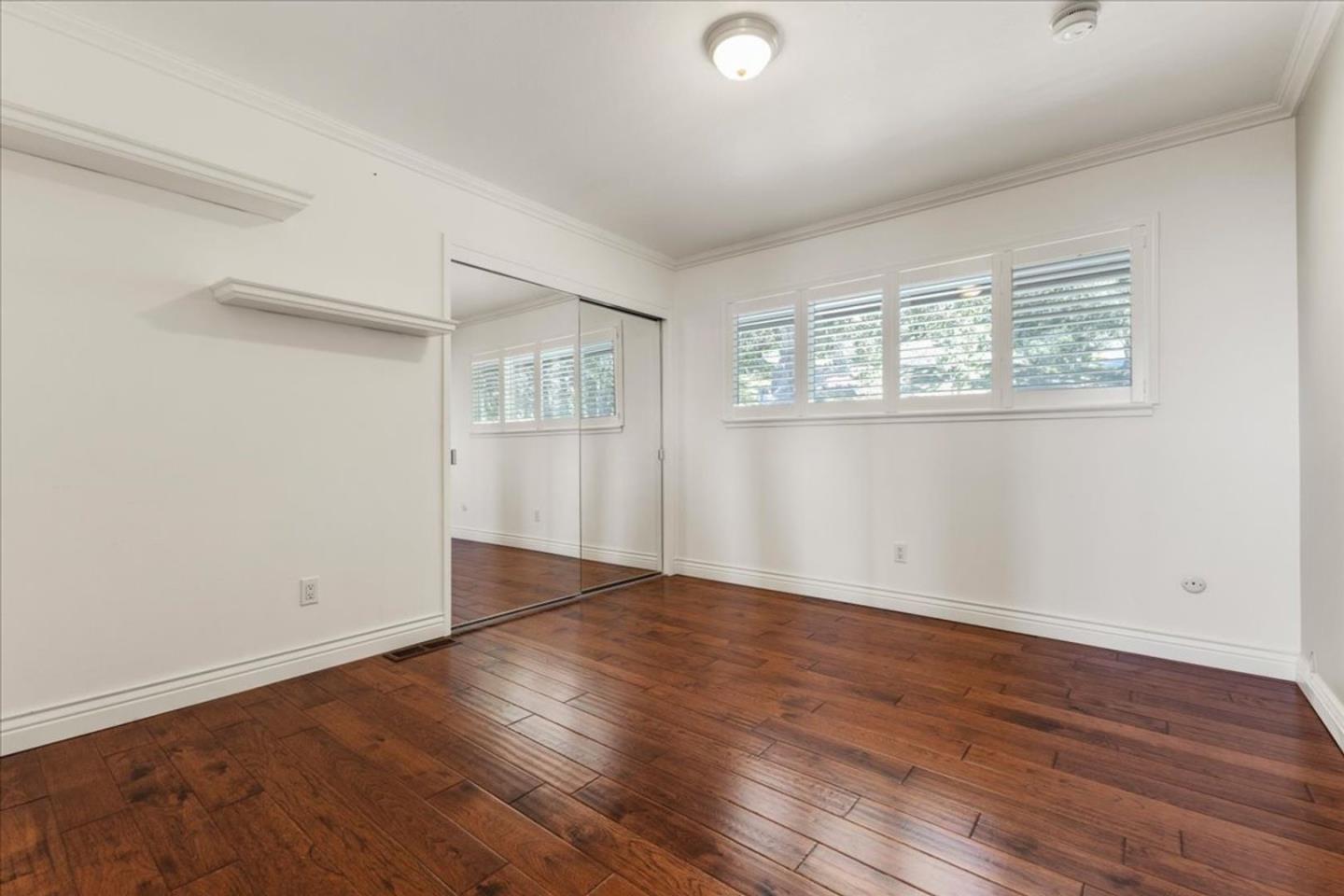 15 Mentone Road Carmel, CA 93923 - Photo 21 of 47 an empty room with wooden floor and windows