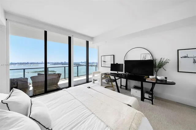 a view of a room with wooden floor and a bathroom