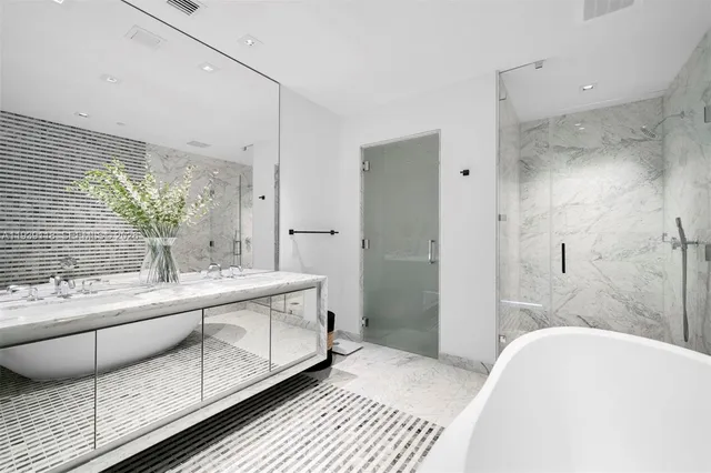 a bathroom with a granite countertop sink a toilet and shower