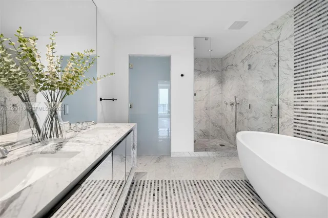 a bathroom with a sink a mirror and a bathtub