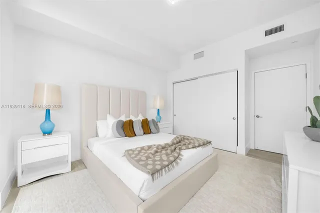 a spacious bedroom with a large bed and a large window