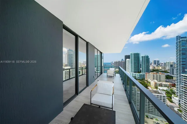 a view of city from balcony with seating space