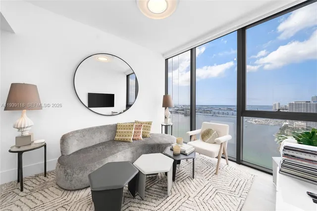a living room with furniture and a large window