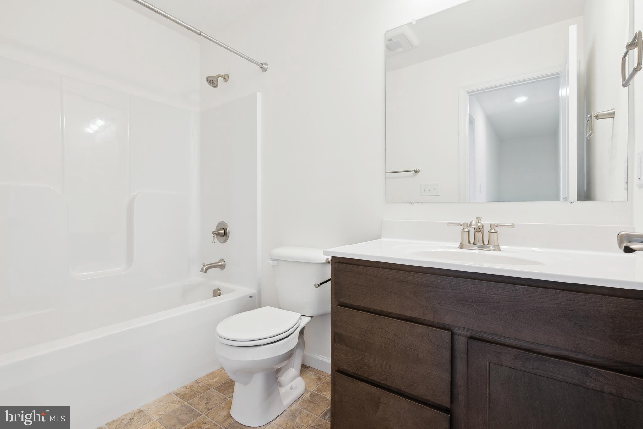 540 Ripple Drive, Unit 47 Hanover, PA 17331 - Photo 17 of 19 a bathroom with a sink a toilet and a mirror