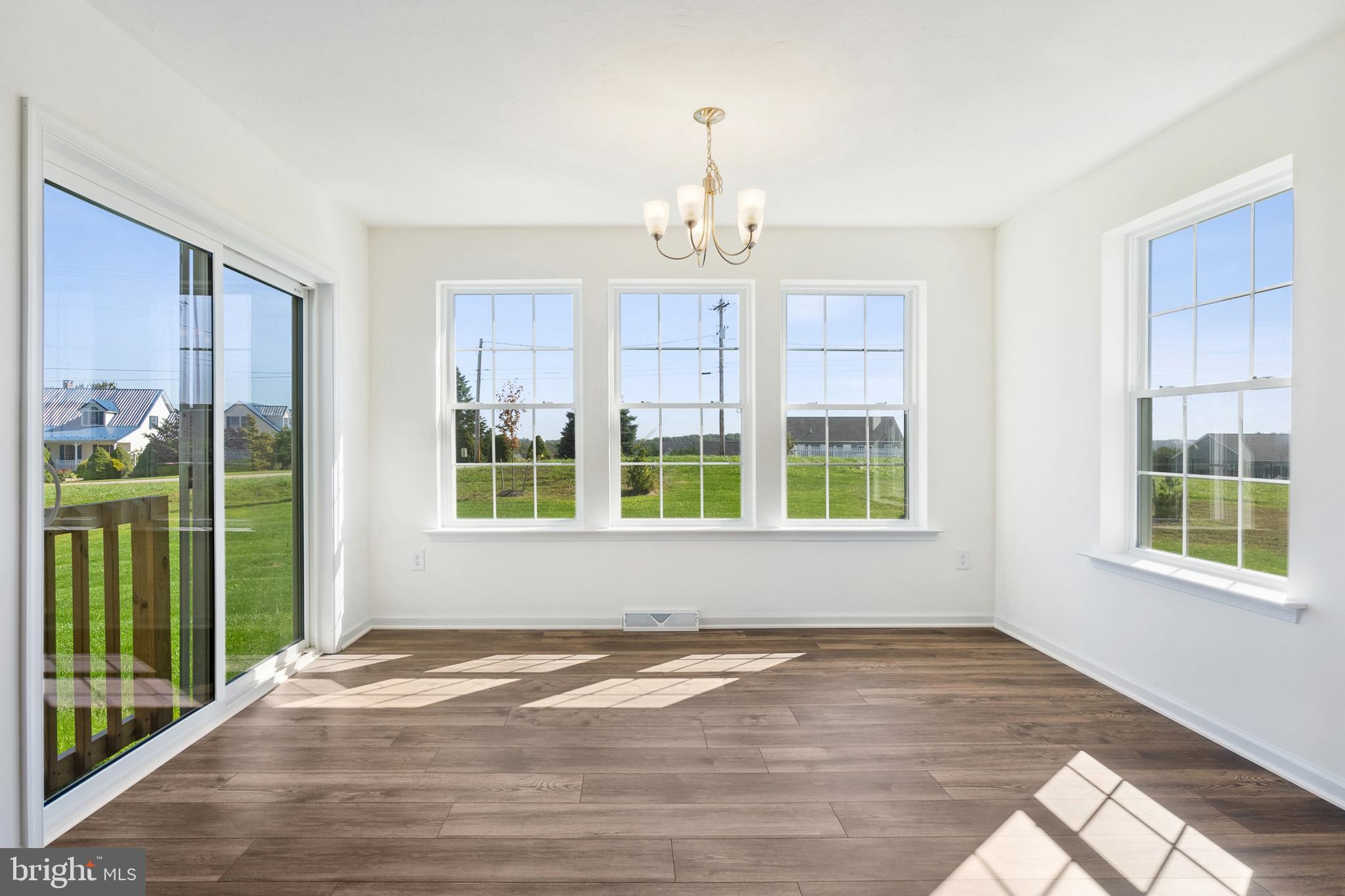 540 Ripple Drive, Unit 47 Hanover, PA 17331 - Photo 8 of 19 a view of an empty room with wooden floor and a window