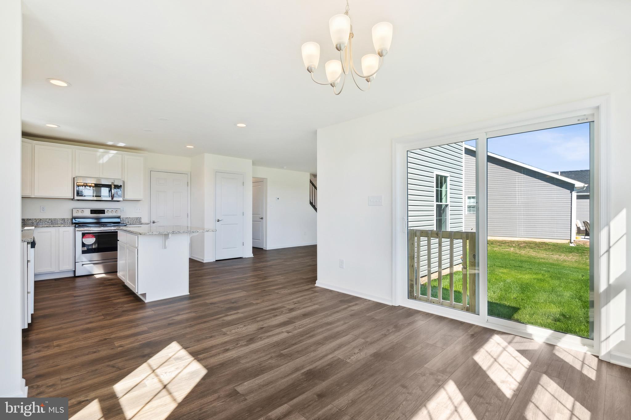 540 Ripple Drive, Unit 47 Hanover, PA 17331 - Photo 9 of 19 a view of kitchen and hall with wooden floor and windows