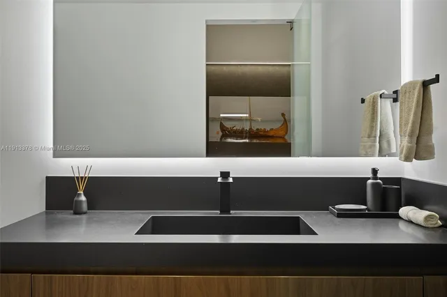 a view with granite countertop a sink and a stove